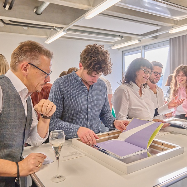Personen auf der Ausstellung sehen sich die Bücher an